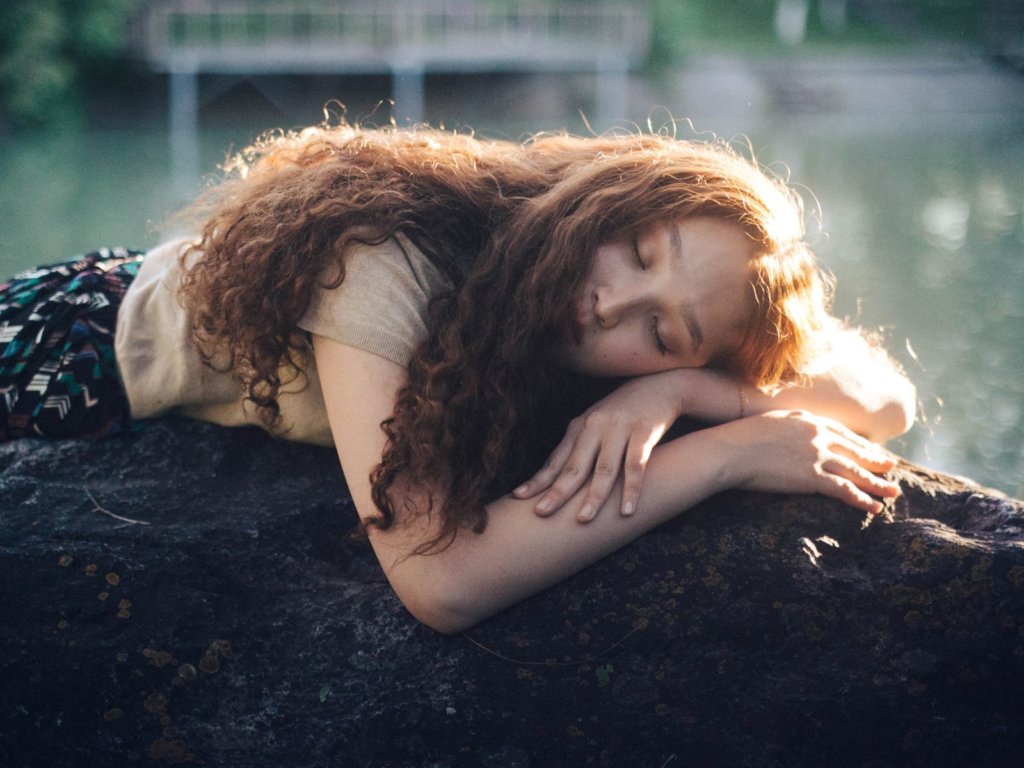 woman sleeping on a tree