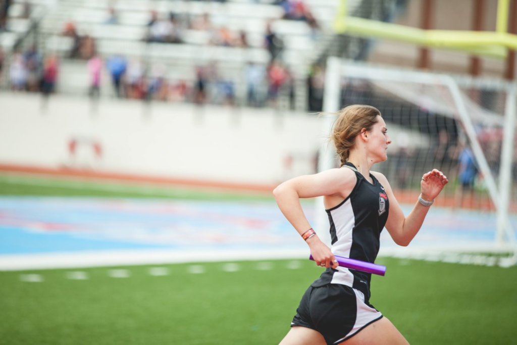 woman running with a baton