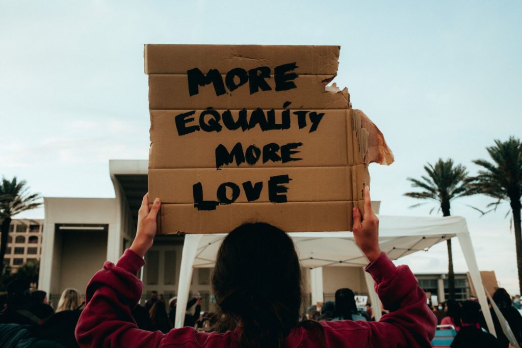 cardboard sign more equality, more love