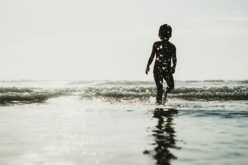 child playing in the ocean